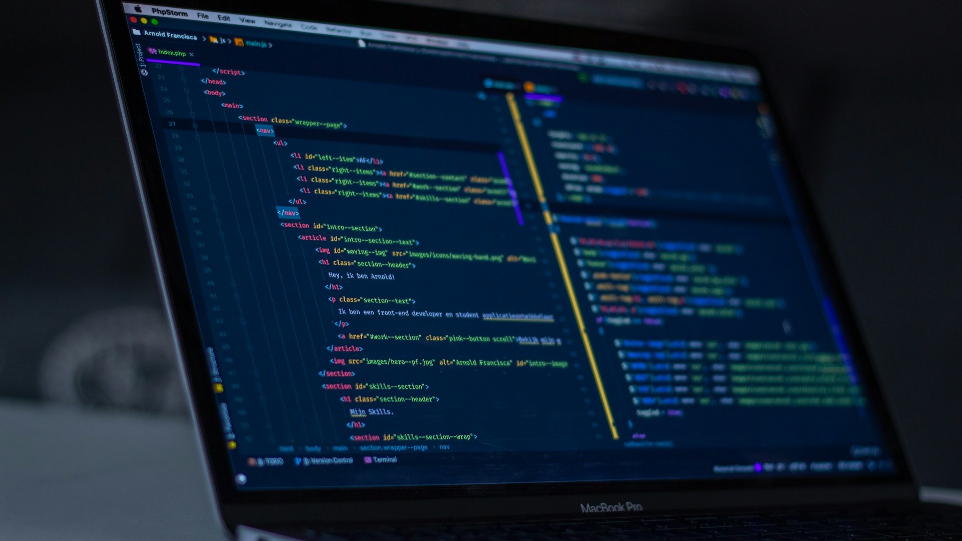 Modern developer desk with dual monitors displaying real web application code in tech office